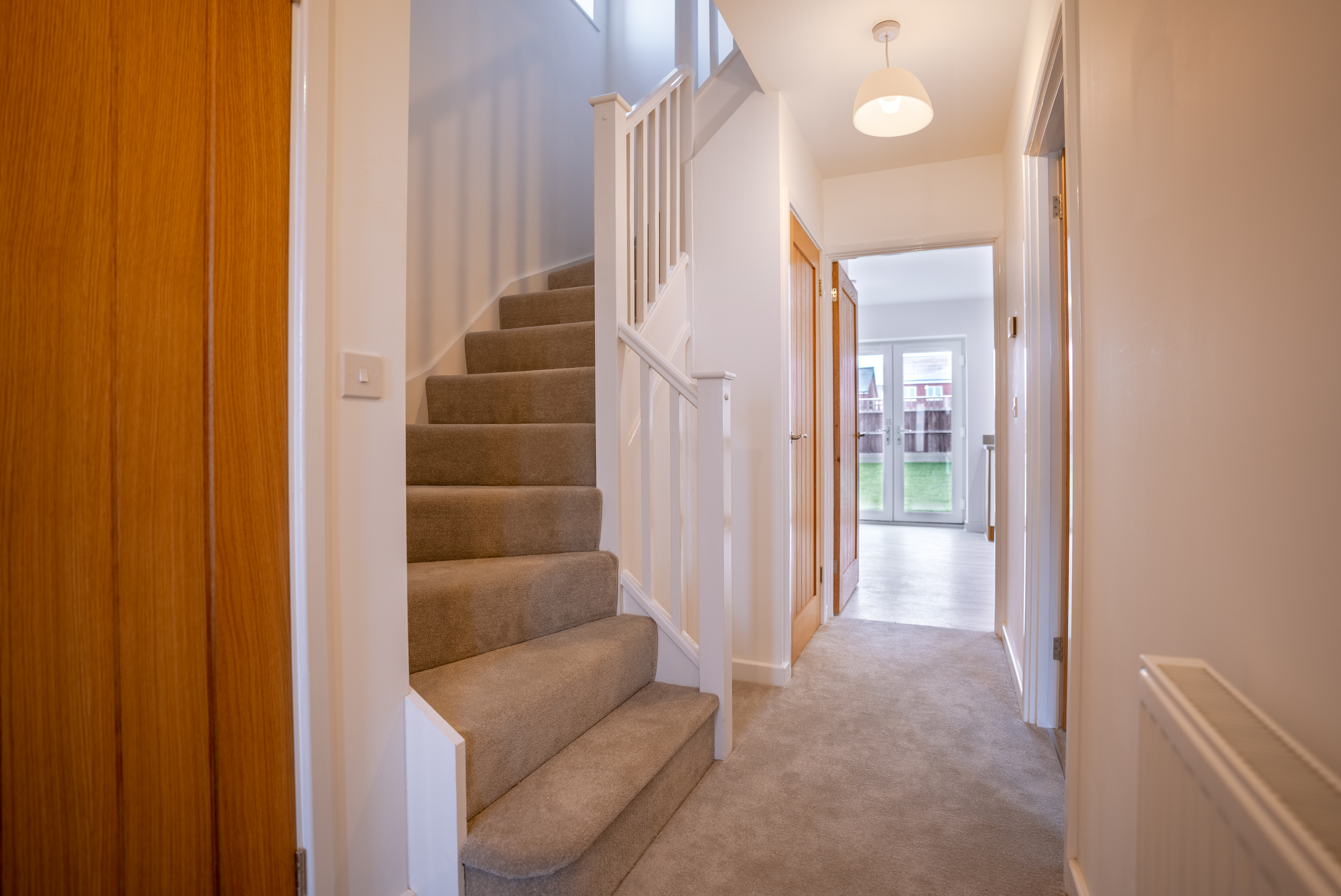 Photograph of the hallway and stairway of one of the new, unoccupied homes at Banbury Lane