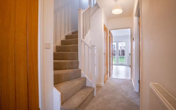 Photograph of the hallway and stairway of one of the new, unoccupied homes at Banbury Lane