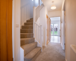 Photograph of the hallway and stairway of one of the new, unoccupied homes at Banbury Lane