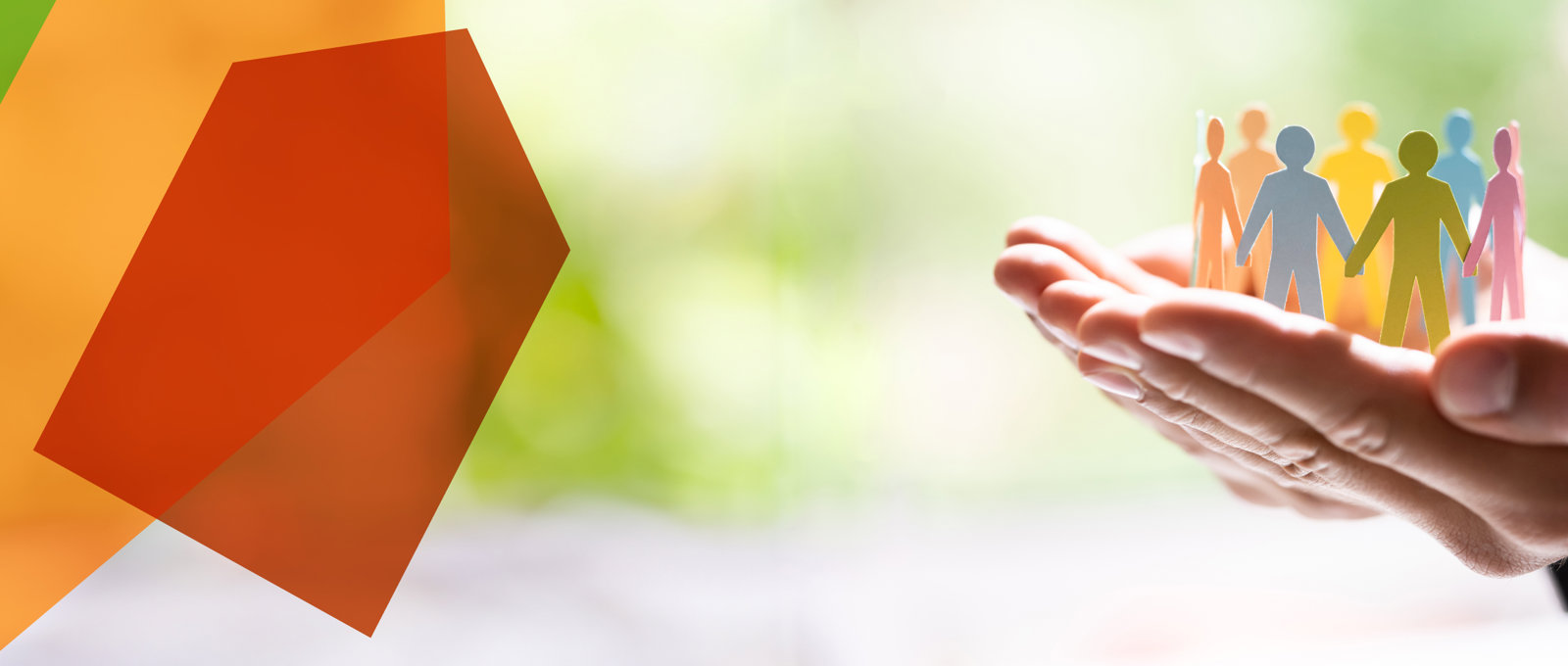 Close up photo of someone holding a cut-out paper chain of people standing in a circle in their cupped hands