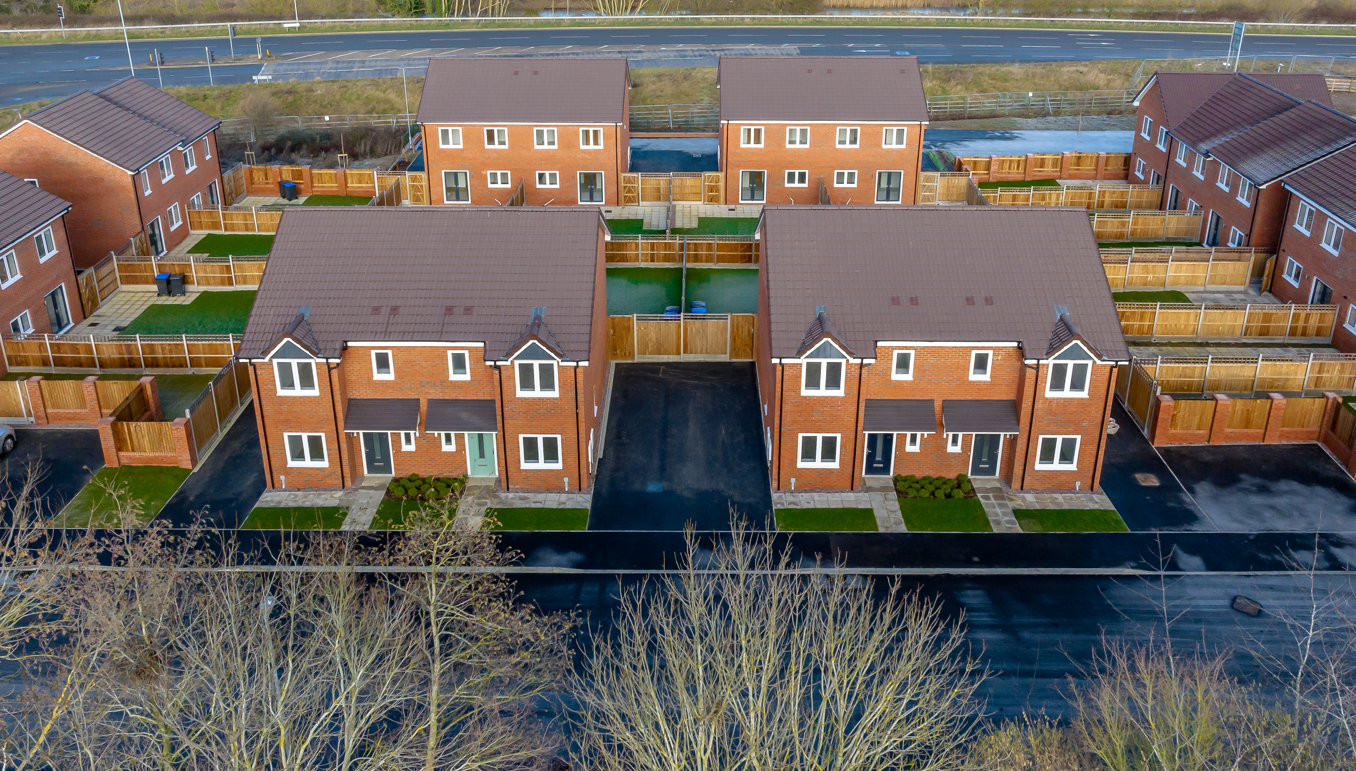 Aerial view of a small modern housing development on what looks like a cold day