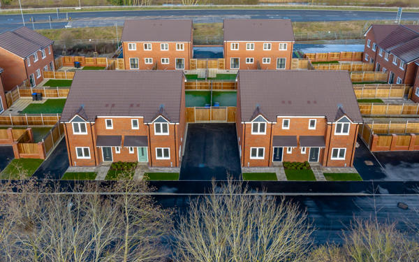 Aerial view of a small modern housing development on what looks like a cold day