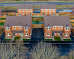 Aerial view of a small modern housing development on what looks like a cold day
