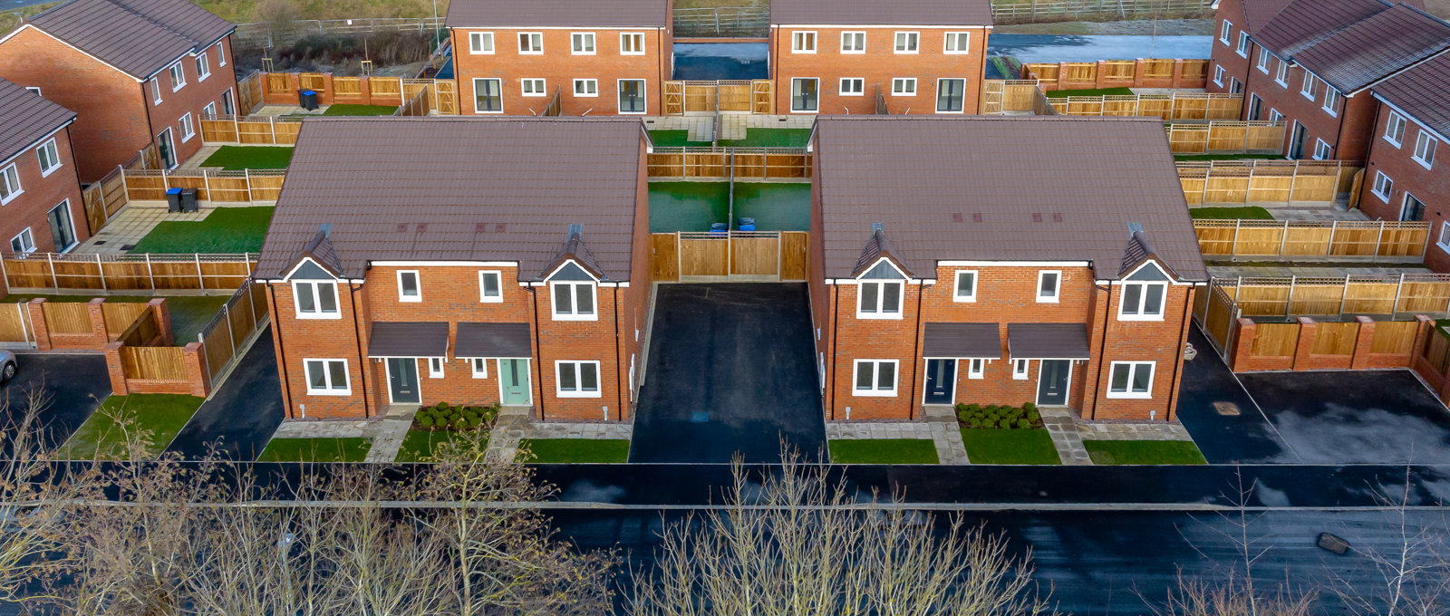 Aerial view of a small modern housing development on what looks like a cold day