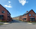 Street view of new homes at Hermitage Drive with properties to both sides