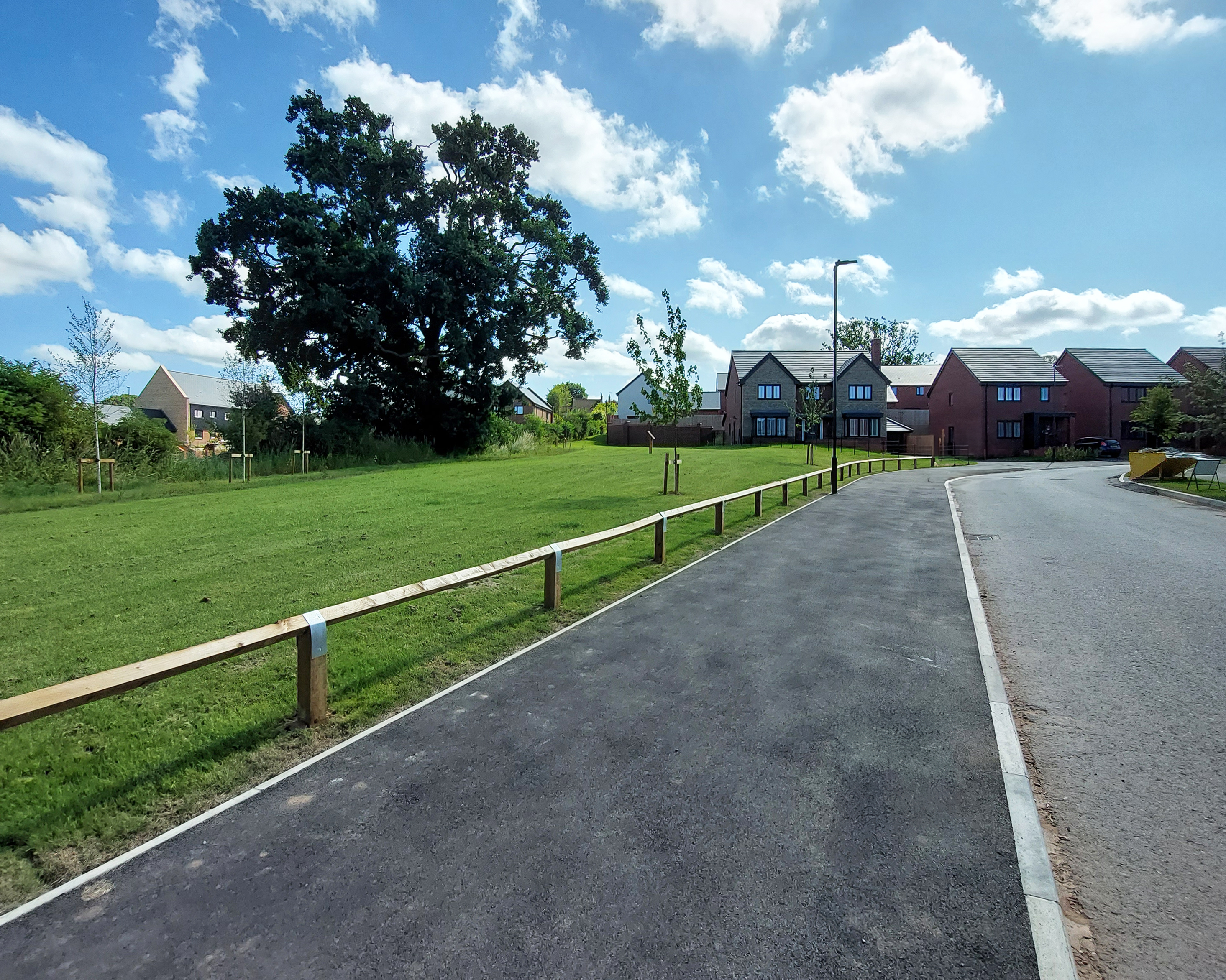 Photograph of the road going into the Hermitage Drive with some of the new homes at the end