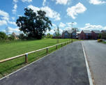 Photograph of the road going into the Hermitage Drive with some of the new homes at the end
