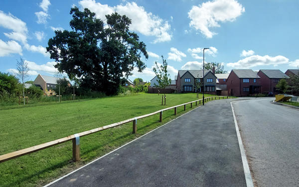 Photograph of the road going into the Hermitage Drive with some of the new homes at the end